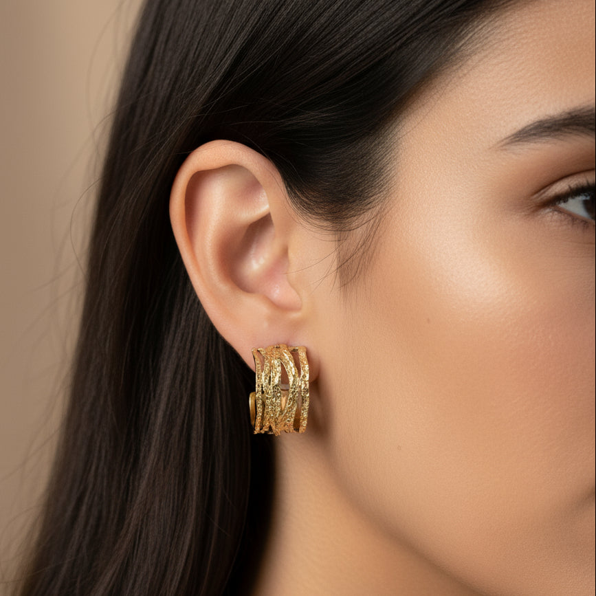 Gold hoop earrings on a white background