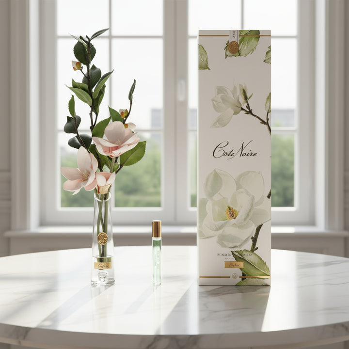 Perfume bottle, packaging, and floral cote noire arrangement.