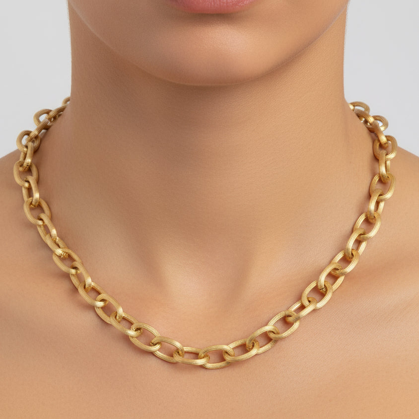 Gold chain necklace on a white background