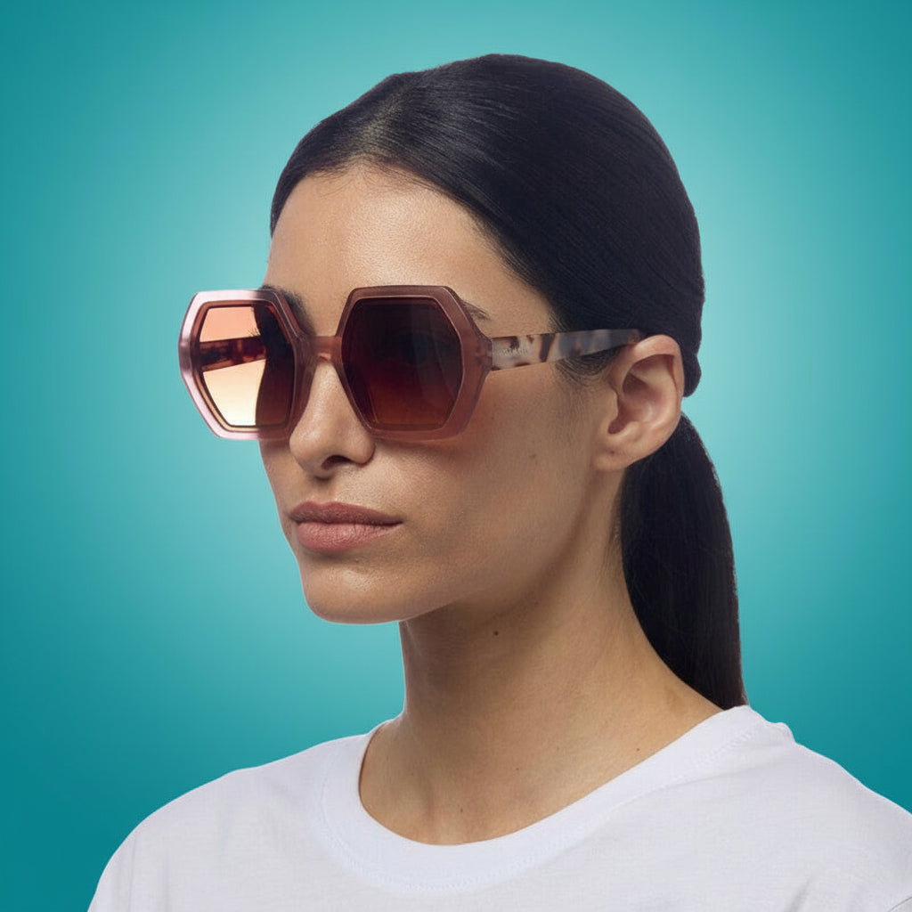 Woman wearing a pair of okkia sunglasses with a white background