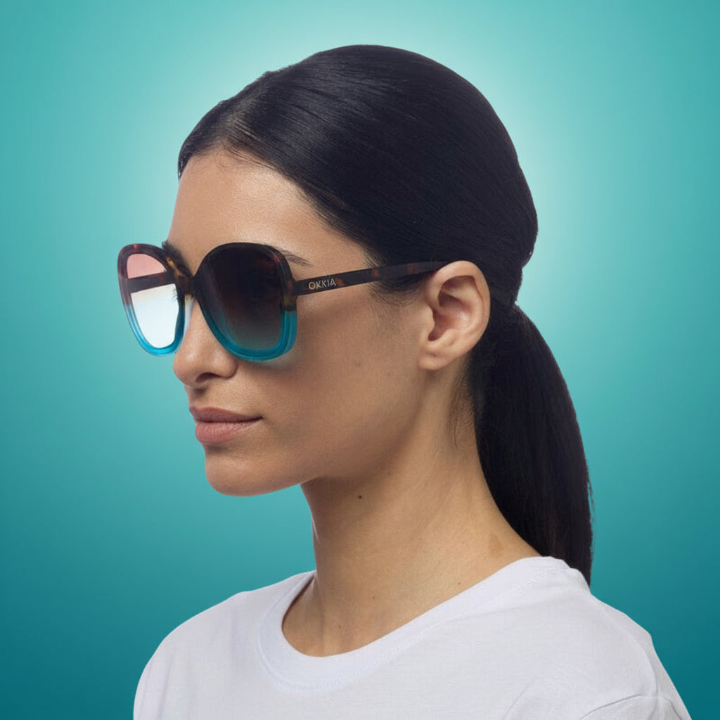 woman wearing stylish womens okki sunglasses in blue and ocelot.