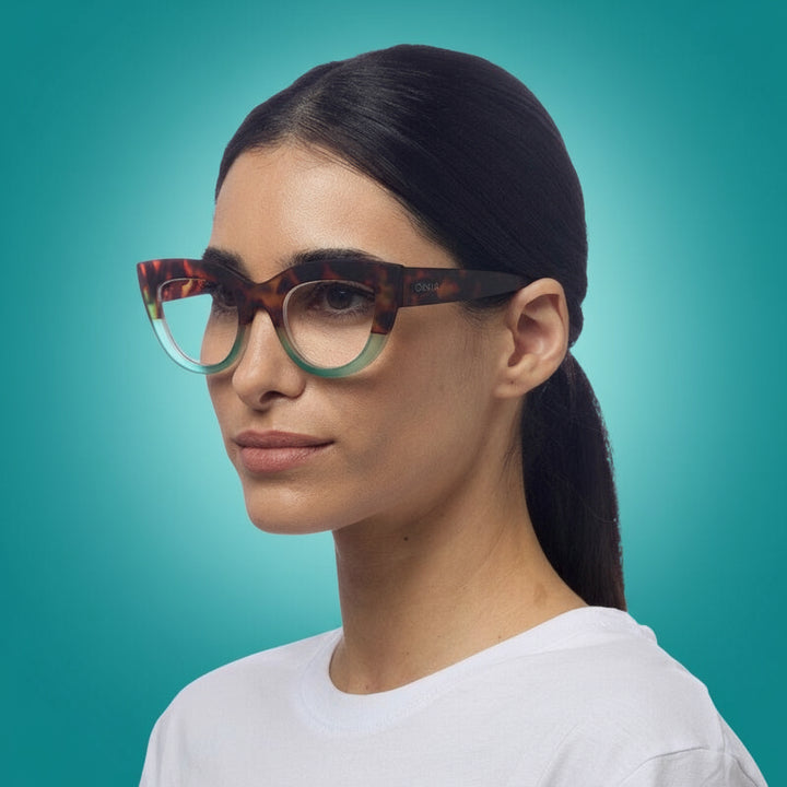 Woman wearing tortoiseshell okkia readin glasses