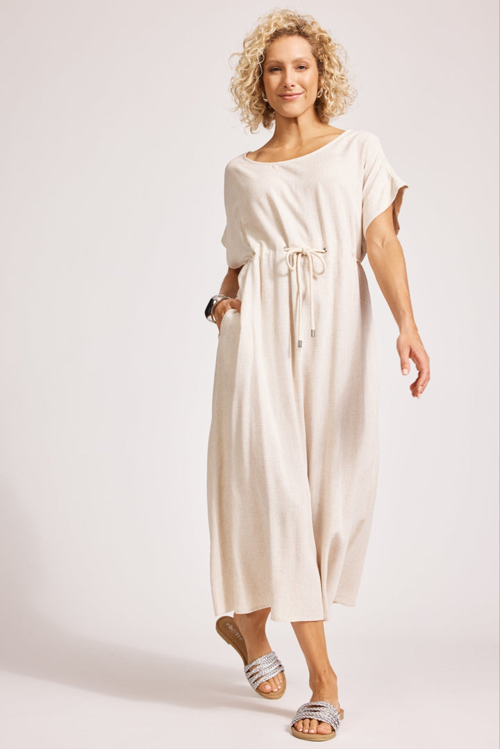 Woman wearing a beige dress on a white background