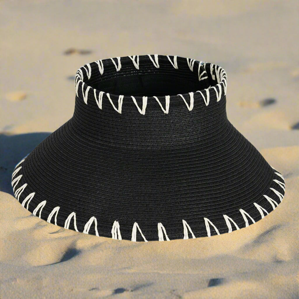 Black sun visor with white trim on a white background