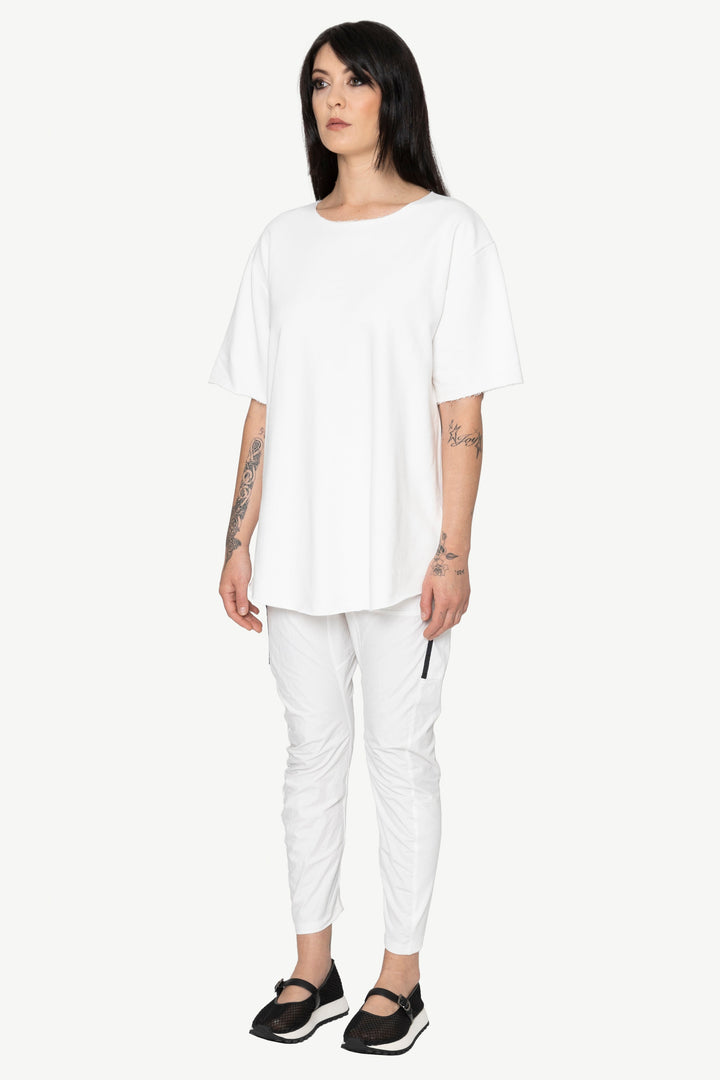 Woman wearing a white outfit on a white background