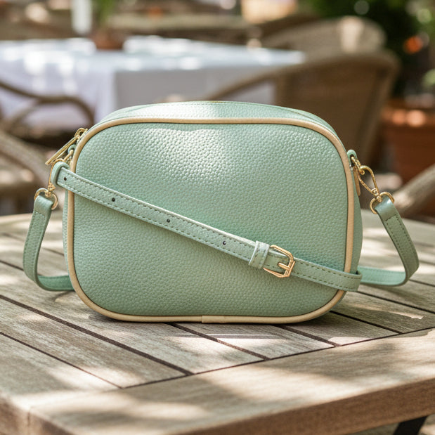 Mint green crossbody bag on a light gray background