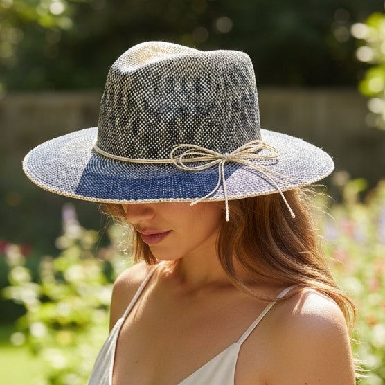 Woven straw hat with denim brim on a white background