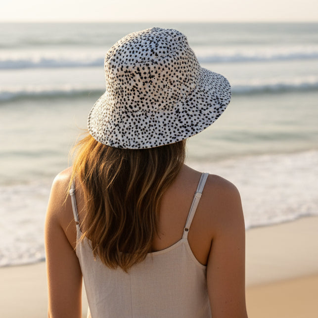 Bucket hat with black dot pattern on a white background