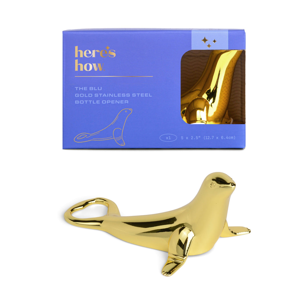 Gold seal-shaped bottle opener with packaging labeled 'here's how' on a white background