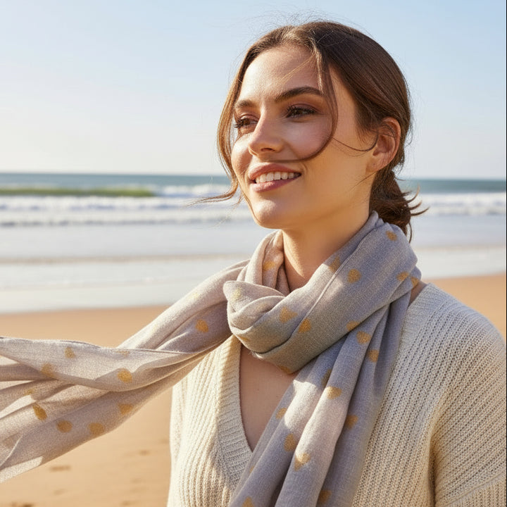 Gray scarf with gold polka dots on a white background