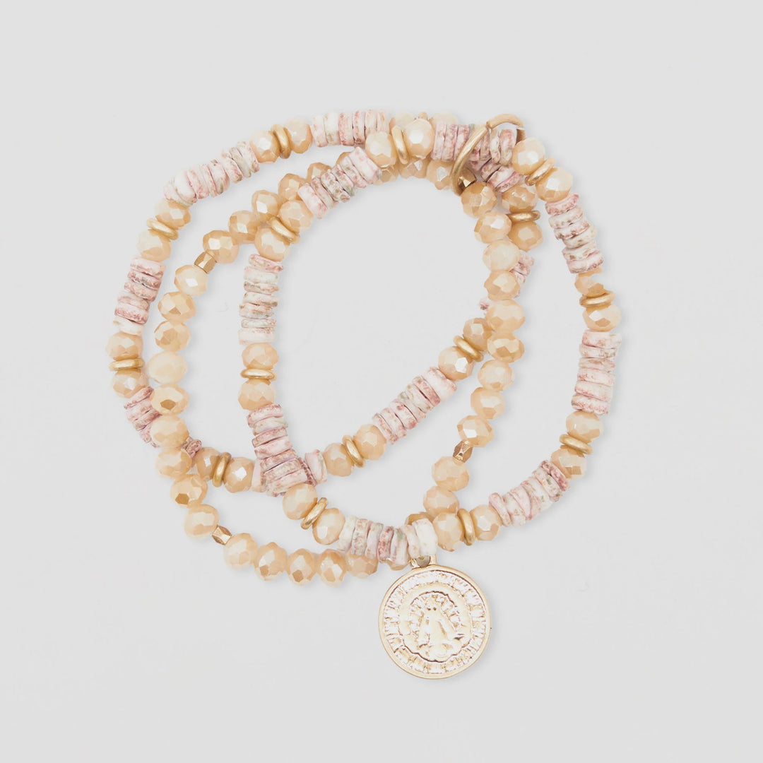 Set of beaded bracelets with a coin charm on a light gray background