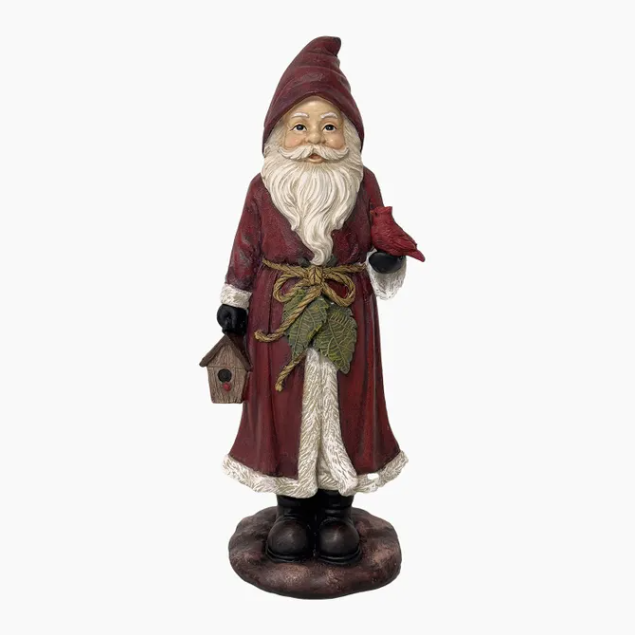 Decorative gnome figure in a red coat holding a birdhouse on a white background