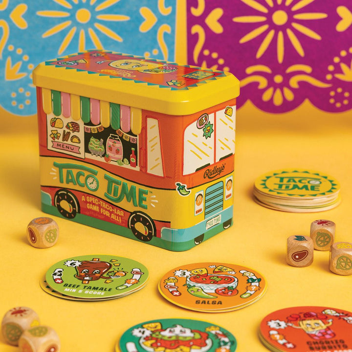 Colorful 'Taco Time' game set with a toy truck-shaped tin on a yellow background.