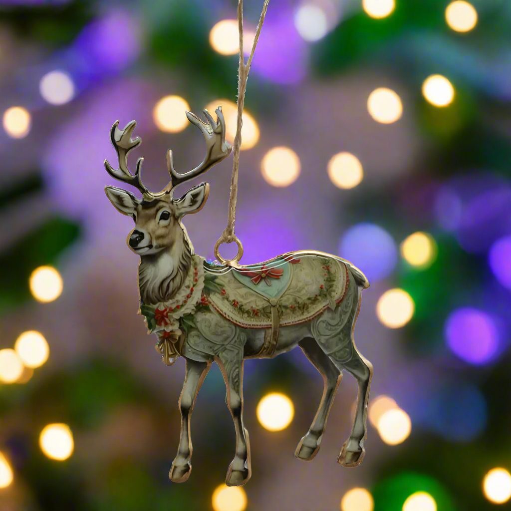 Decorative reindeer ornament with a patterned saddle blanket on a white background