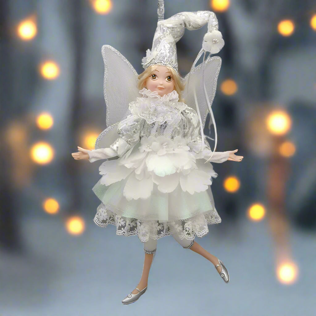 Decorative fairy figurine with white dress and wings on a white background