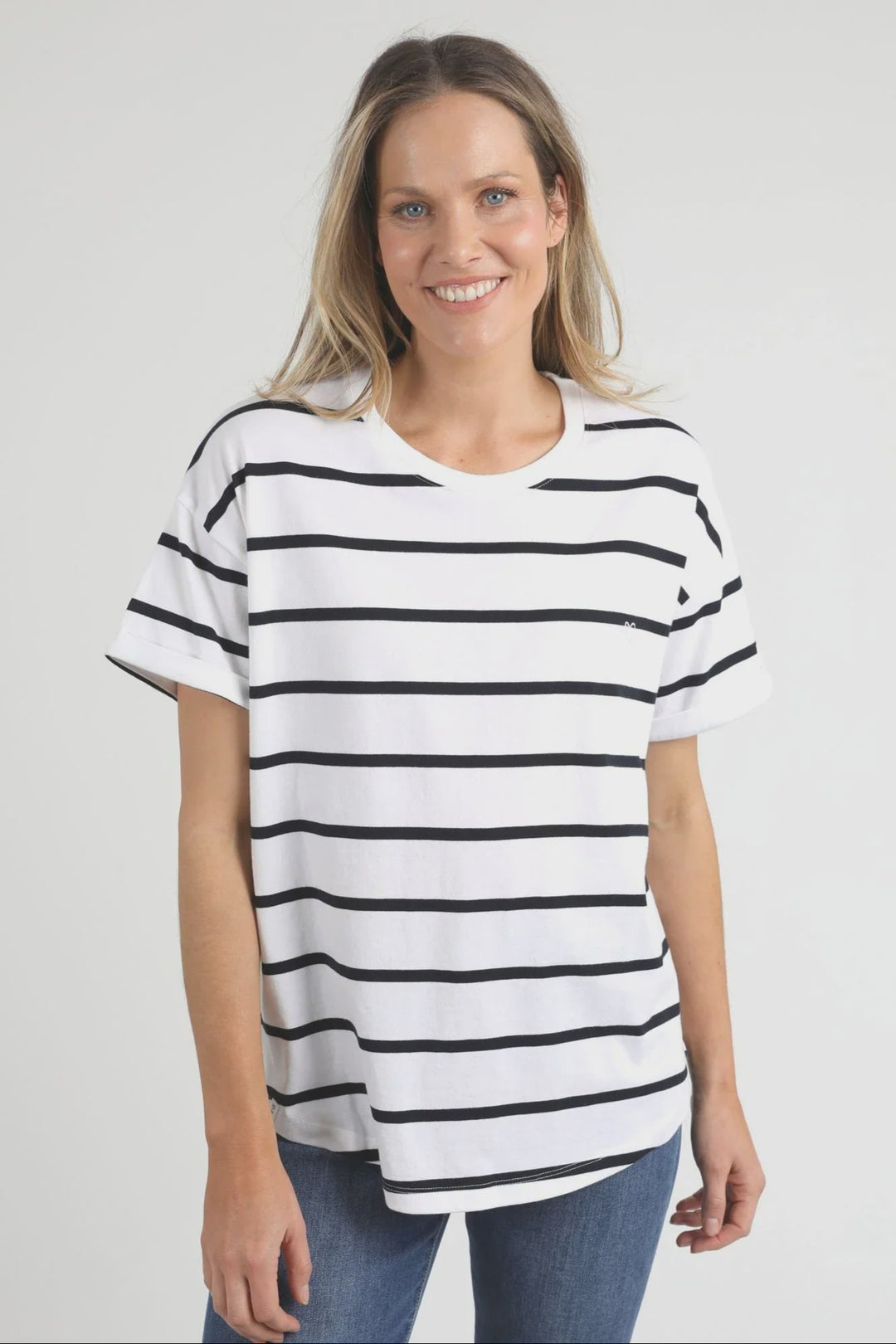 Woman wearing a black and white striped elm halli t-shirt on a plain background