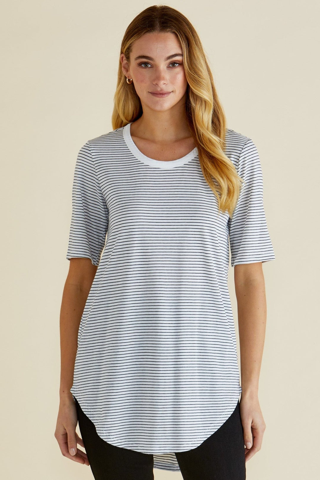Woman wearing a striped t-shirt on a beige background