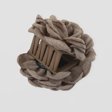 Brown hair tie with a small wooden comb on a light gray background