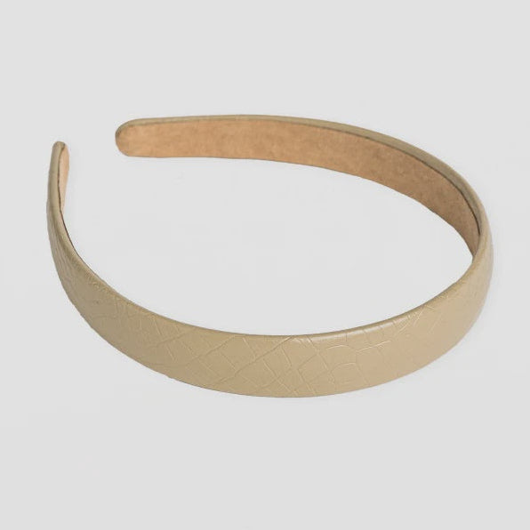 Beige headband on a light gray background