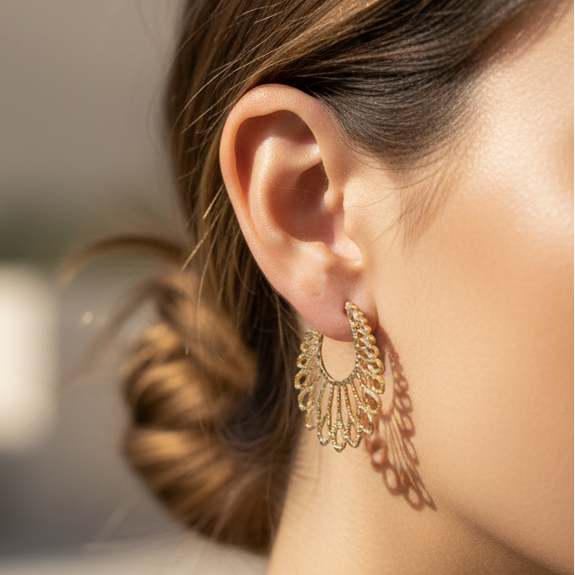 Pair of gold earrings on a white background