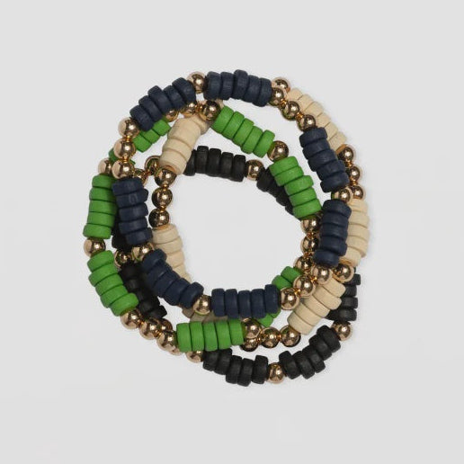 Stack of colorful beaded bracelets on a light gray background