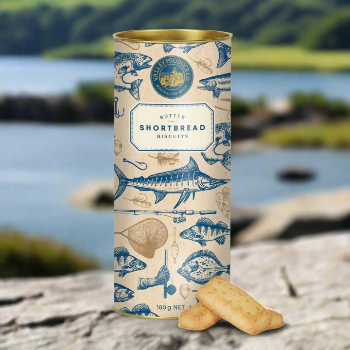 Tall cylindrical container of FISHING THEMED BUTTER shortbread biscuits with fish illustrations on a white background
