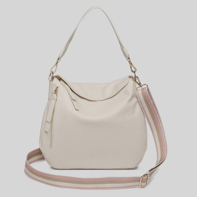 Beige handbag with a pink strap on a light gray background