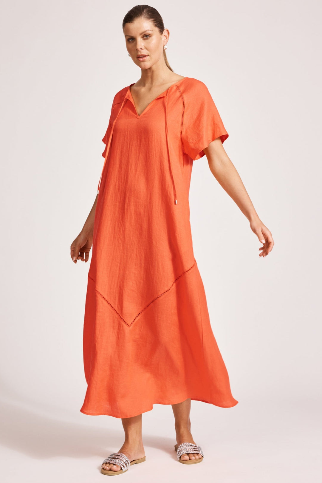 Woman wearing an orange dress on a white background