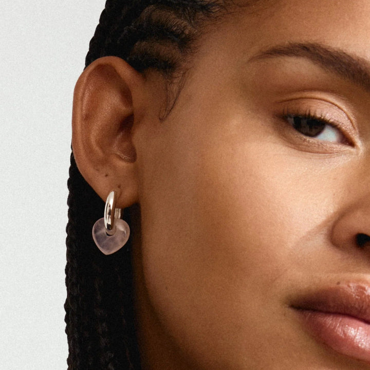 Woman wearing a black jacket with a neutral background