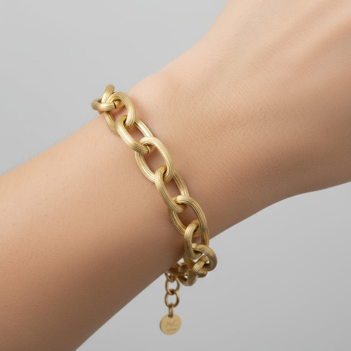 Gold chain bracelet on a white background
