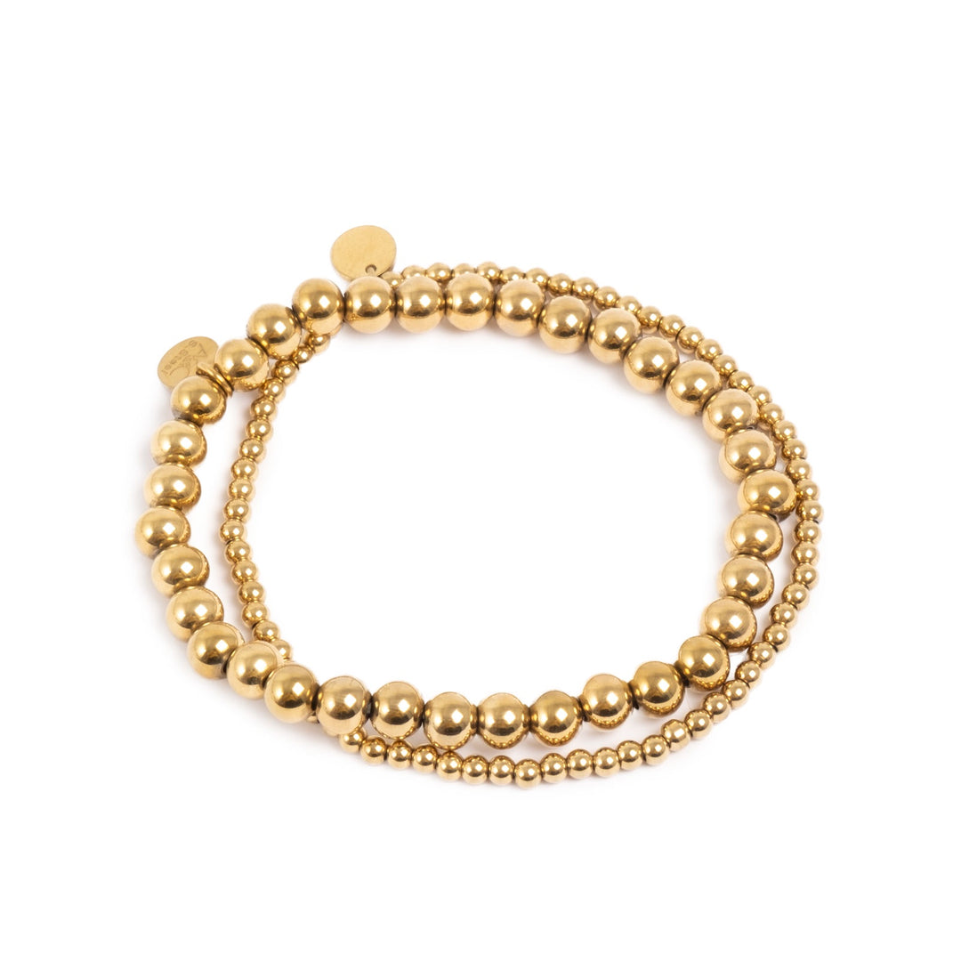Gold beaded bracelet on a white background