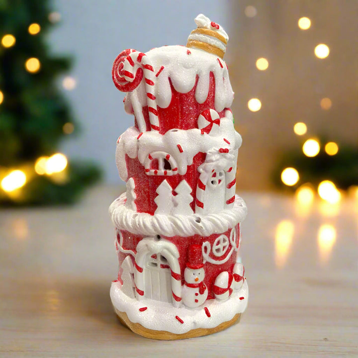 Decorative gingerbread house with candy cane details on a white background