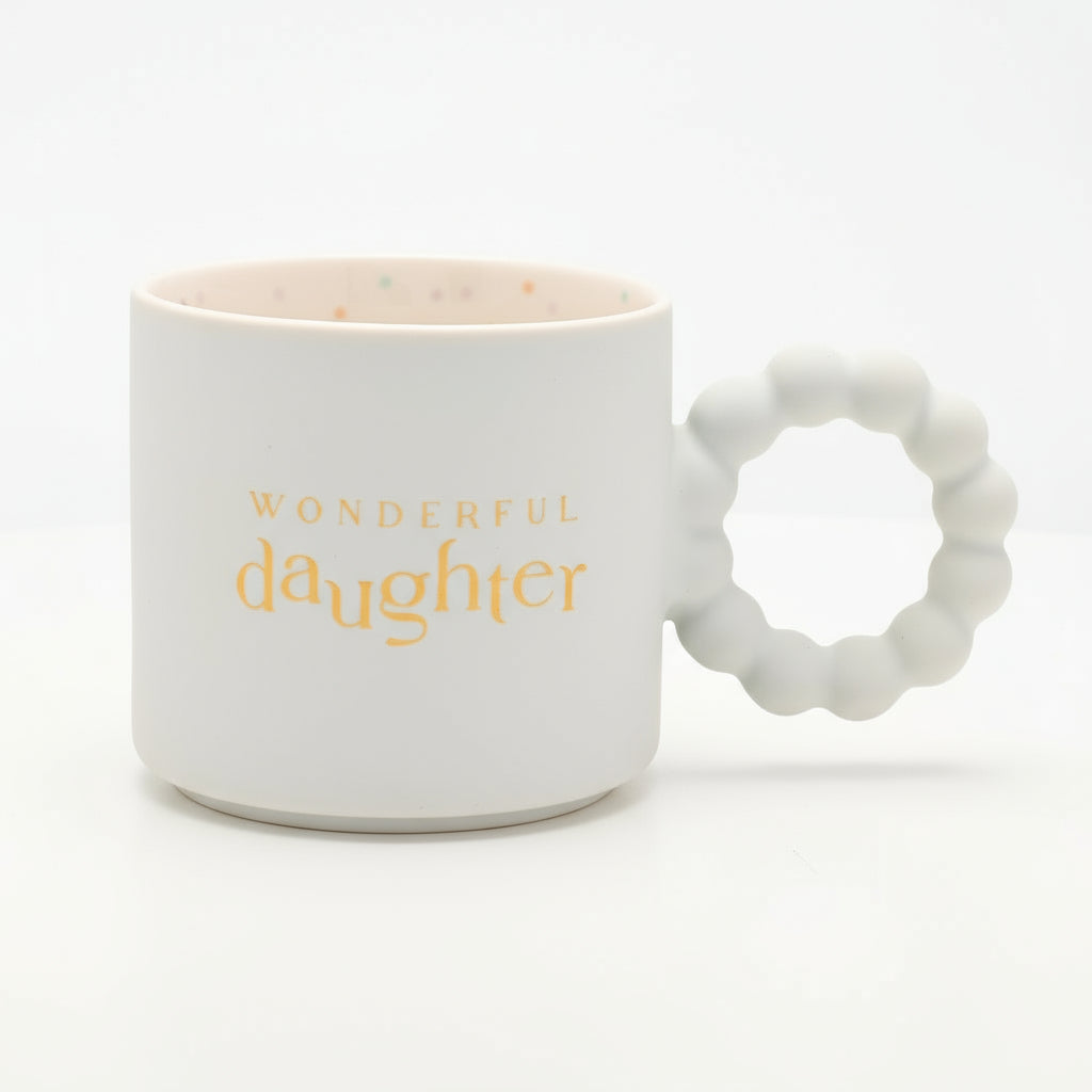 White mug with 'Wonderful Daughter' text and textured handle on a white background