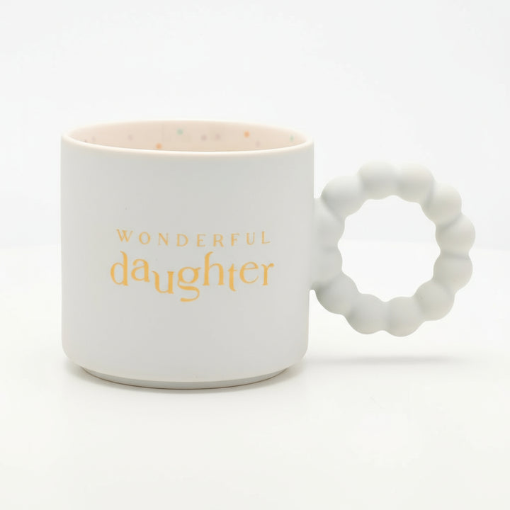 White mug with 'Wonderful Daughter' text and textured handle on a white background