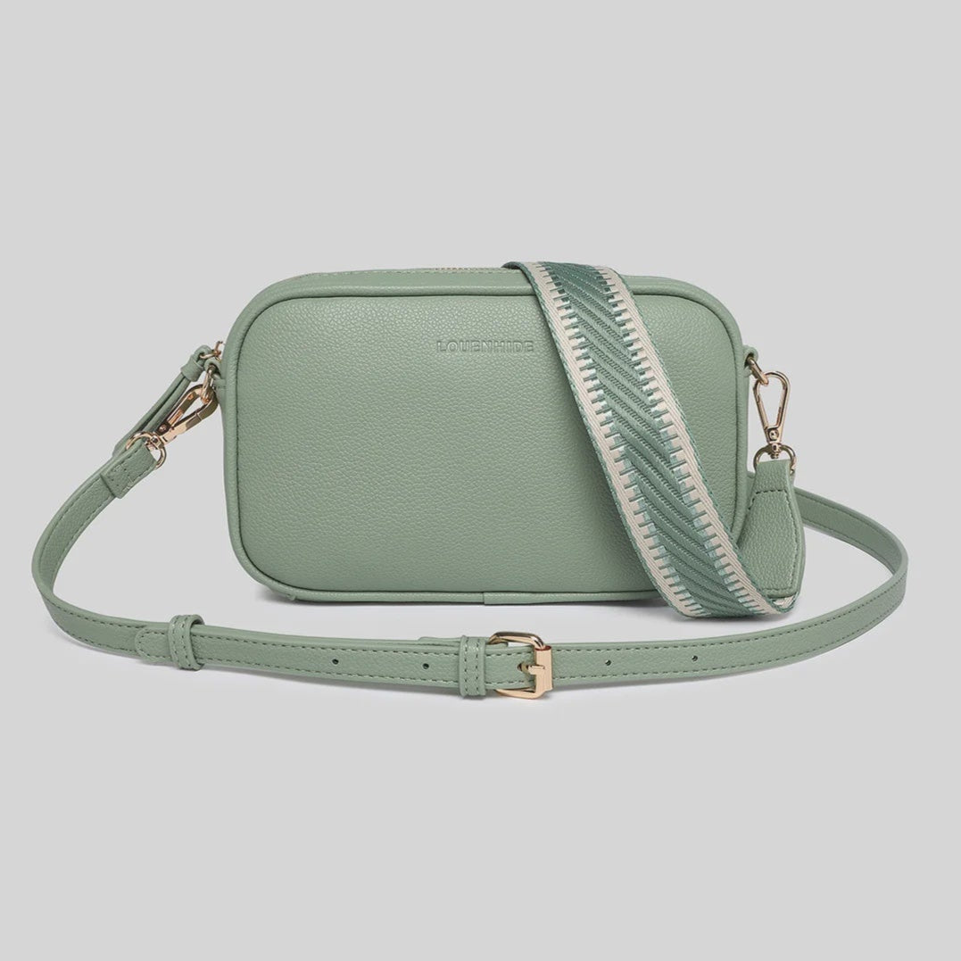 Green crossbody bag with a strap on a light gray background