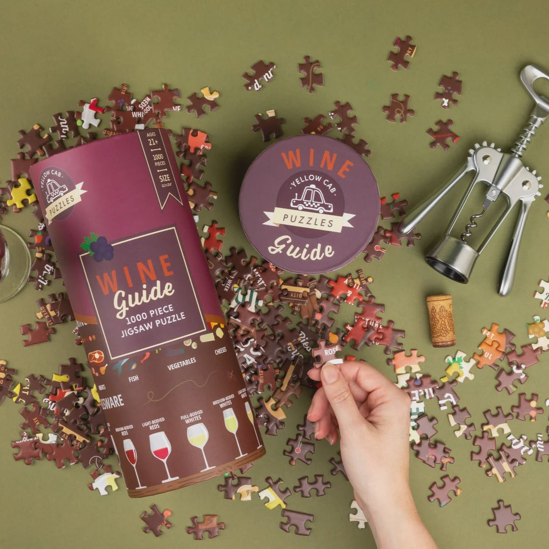 Wine-themed puzzle with pieces and packaging on a green background