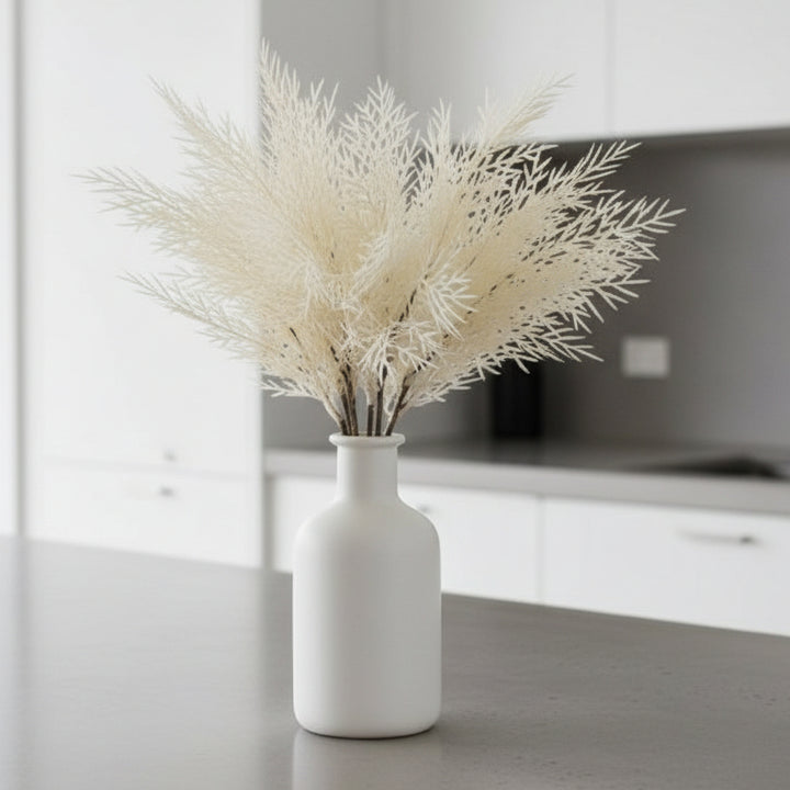 Artificial white tree branch on a light gray background