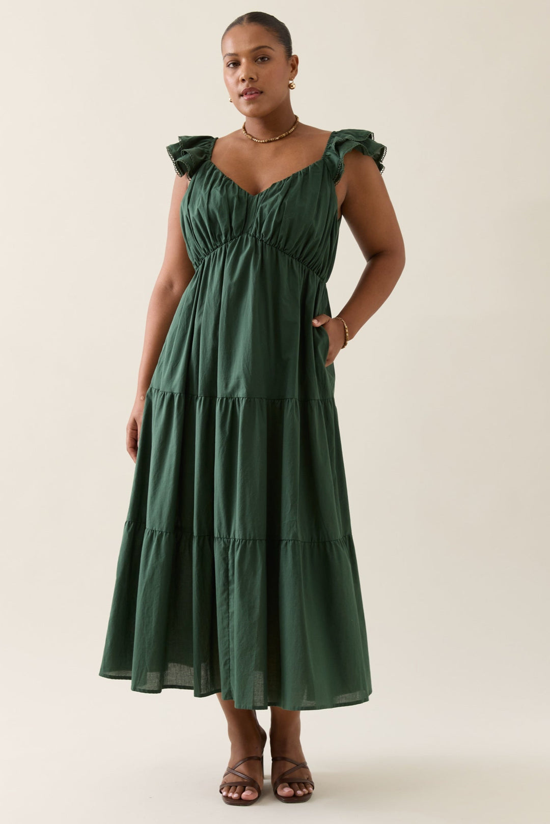 Woman wearing a green dress against a white background