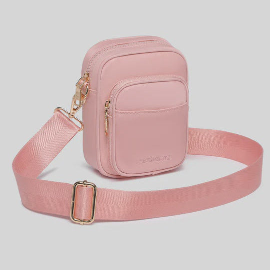 Pink crossbody bag with a strap on a light gray background