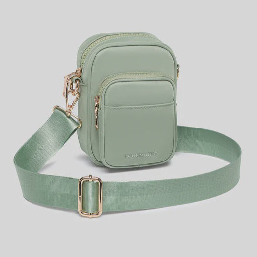Green crossbody bag with a strap on a light gray background