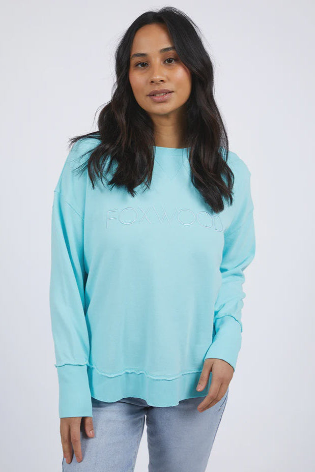 Woman wearing a light blue sweater against a white background