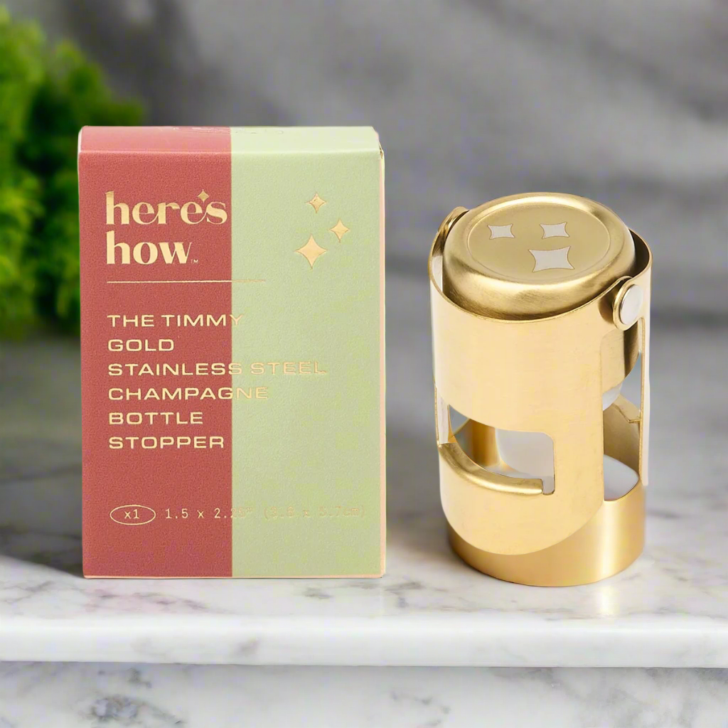 Gold stainless steel champagne bottle stopper with packaging on a white background