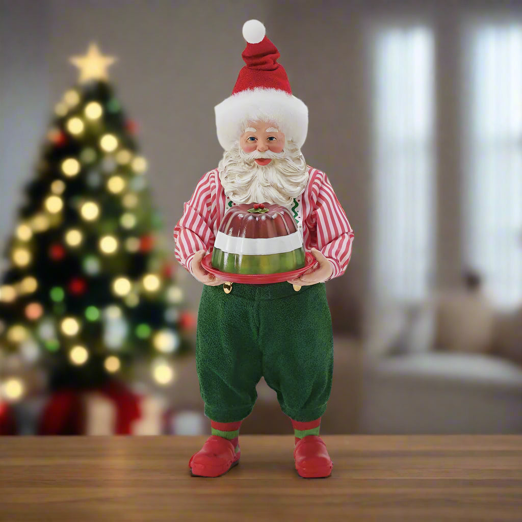 Traditional Santa Claus figure holding a gift on a white background
