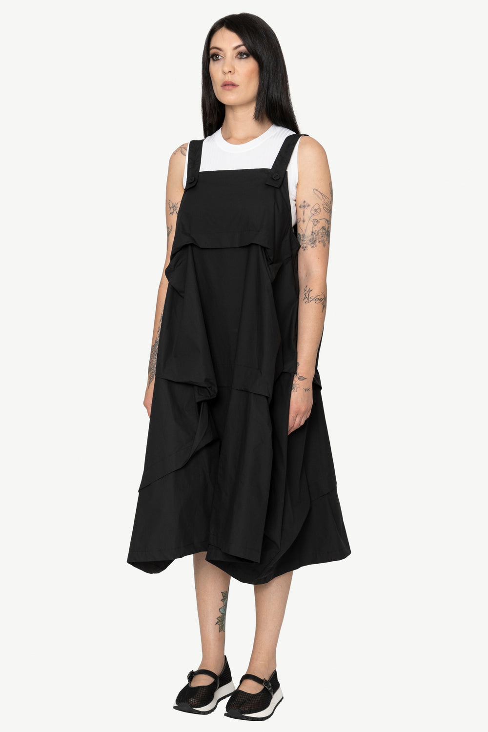 Woman wearing a black layered dress on a white background