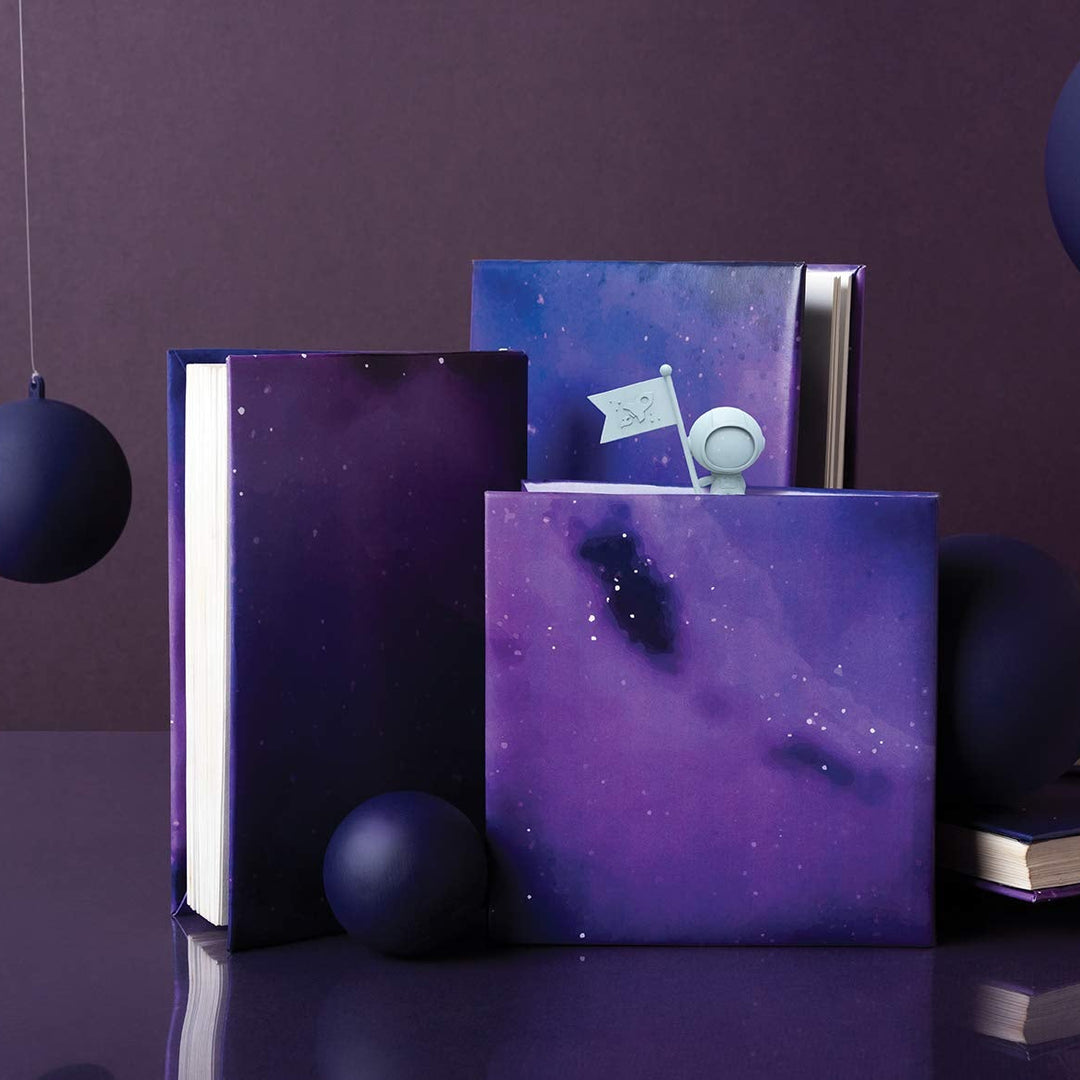 Purple galaxy-themed books with decorative spheres on a dark background