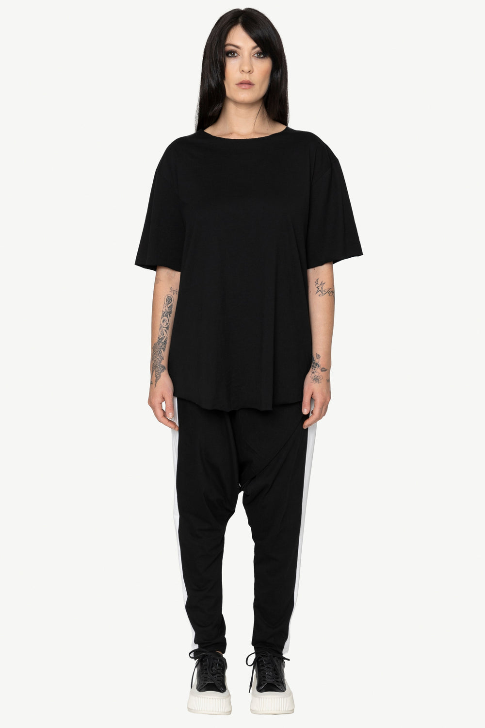Person wearing a black outfit on a white background