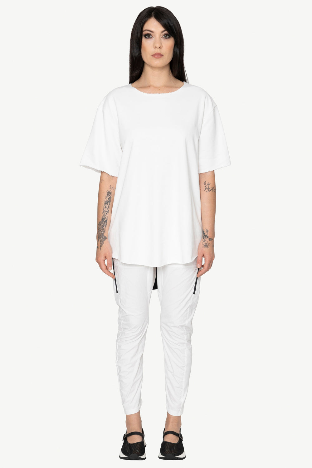 Person wearing a white outfit on a white background