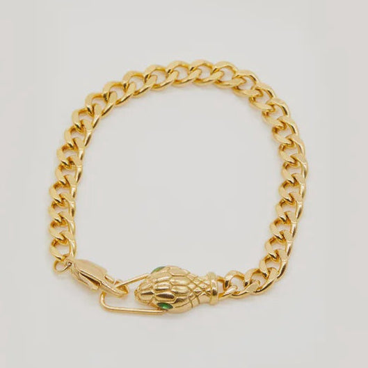 Gold chain bracelet with a clasp on a light gray background