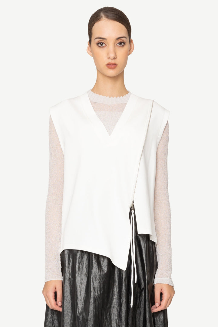 Woman wearing a white blouse and black leather skirt on a white background