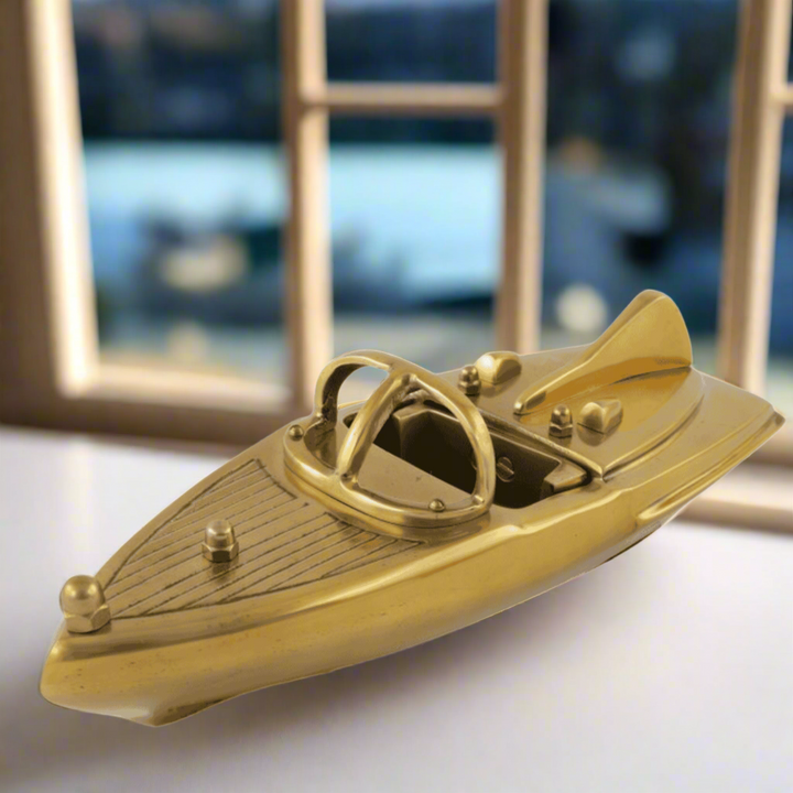 Gold model of a speedboat on a white background